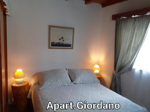 ディナ・ウアピにあるApart.Giordanoのベッドルーム1室(白いベッド1台、ランプ2つ付)