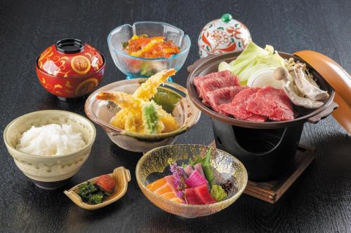 a table topped with bowls of different types of food at Jakomaru Park Tsuda in Sanuki