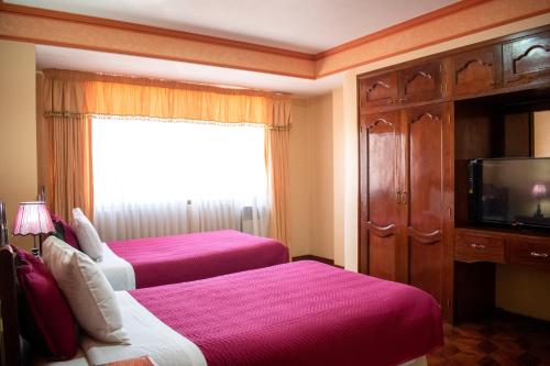 Habitación de hotel con 2 camas y TV en Hotel Diamante Azul, en La Paz