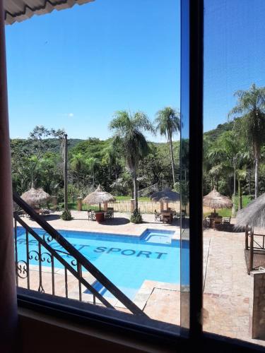 a view of a swimming pool from a window at Resort Sport in Independencia