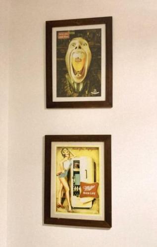 two pictures on a wall with a picture of a refrigerator at Temporarios Colón Habitación Céntrica 2 Camas in Posadas