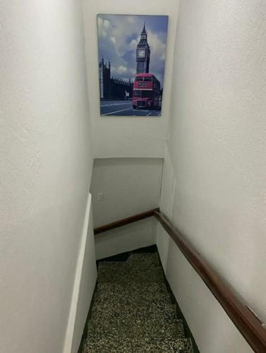 a narrow hallway with a picture of a red bus at Temporarios Colón Habitación Céntrica 2 Camas in Posadas