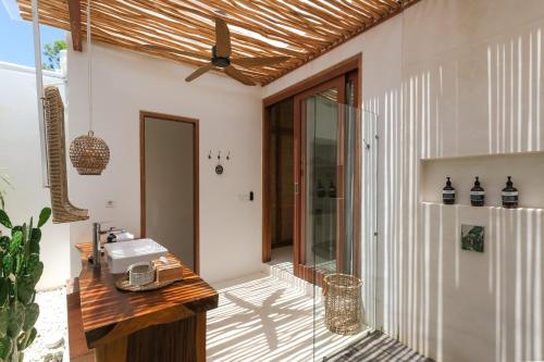 a home with a glass door and a counter at Amaka Villas in Uluwatu