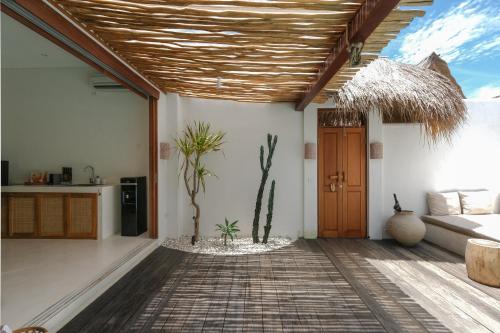 a living room with a couch and a wooden ceiling at Amaka Villas in Uluwatu