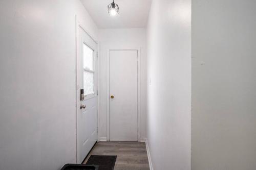 a hallway with a white door and a window at Harmony Home Near University of Waterloo in Waterloo