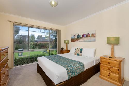 a bedroom with a bed and a large window at Park Avenue - Forest Hill in Forest Hill