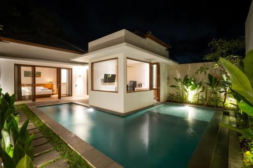 a swimming pool in the backyard of a villa at night at Atania Villa's Bingin in Uluwatu
