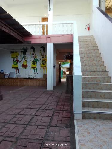 ein Gebäude mit Treppen und einer Wand mit Graffiti in der Unterkunft Wjv Inn Sta. Fe Bantayan in Ocoy