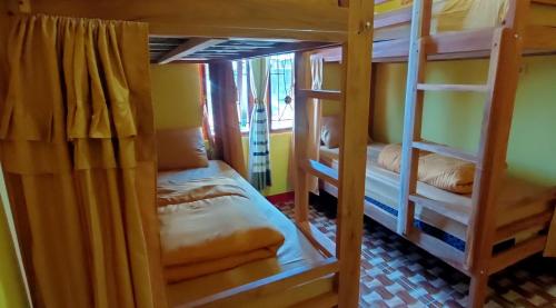 a room with two bunk beds in a room at Ruteng Hostel in Ruteng