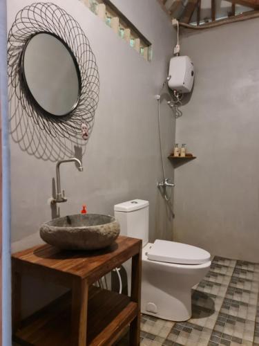 a bathroom with a sink and a toilet at Villa Kayu Yogyakarta in Yogyakarta