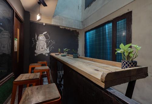 a bar with a wooden counter and some chairs at AmigosIndia in New Delhi