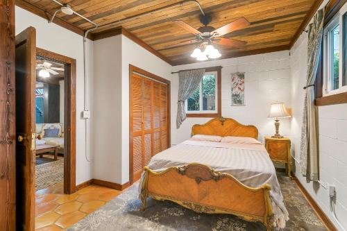 a bedroom with a bed and a ceiling fan at Pasters Apartment in Deconsecrated Church in New Orleans