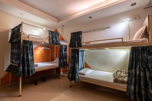 a room with three bunk beds in it at AmigosIndia in New Delhi