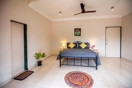 a bedroom with a bed and a ceiling fan at NomadGao Vila Nova - Comfort, Great Views, Fast WiFi & Interesting People in Anjuna