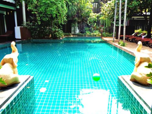 a swimming pool with a golf ball in the middle at Yantarasri Resort in Chiang Mai