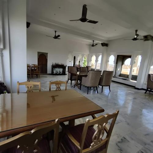 a dining room with a table and chairs in a room at The Fern Bambora Fort, Bambora, Udaipur in Udaipur