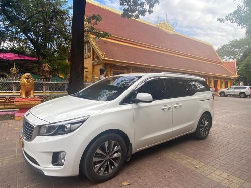 a white suv parked in front of a building at Ali Local Home in Vientiane