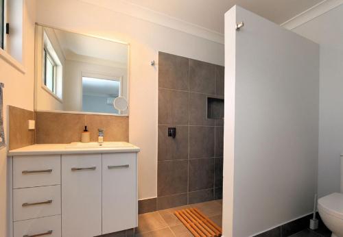 a bathroom with a sink and a shower at Tanner St Retreat in Bargara