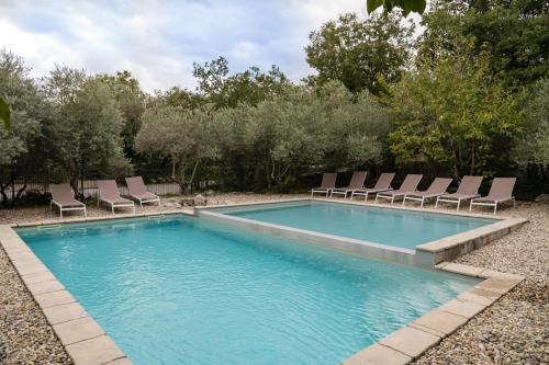 - une piscine avec des chaises longues dans la cour dans l'établissement Roulottes et Cabanes de Saint Cerice, à Vogüé