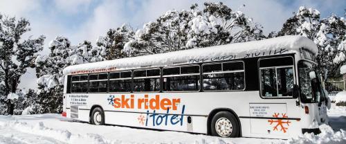a snow covered bus is parked in the snow at Ski Rider Hotel in Perisher Valley