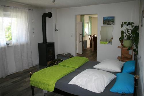 a bedroom with a bed with a green blanket on it at Liebevolle Fewo im Bayerischen Wald in Witzmannsberg