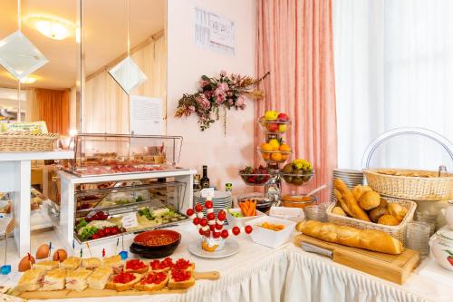a buffet with a lot of food on a table at Hotel Raffaello in Bellaria-Igea Marina