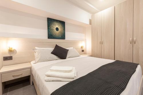 a bedroom with a bed with white sheets and a mirror at No.48 Apartments in Msida