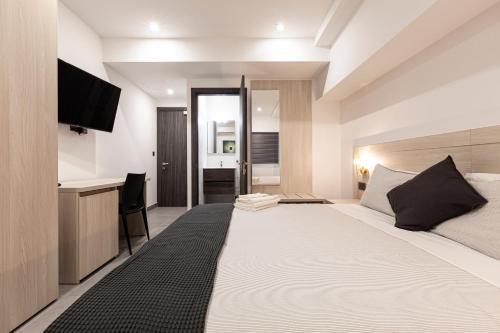 a bedroom with a large bed with a flat screen tv at No.48 Apartments in Msida