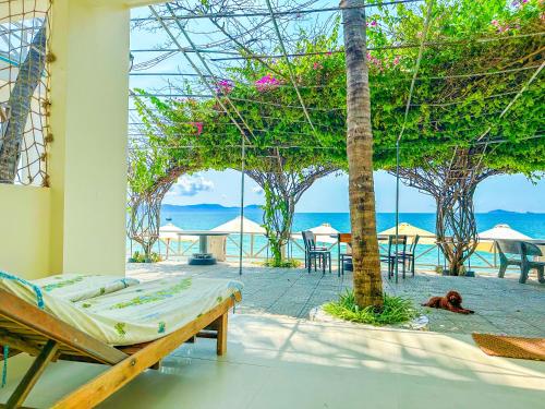 a bedroom with a bed and a view of the ocean at Paradise Resort Doc Let - All Inclusive in Doc Let