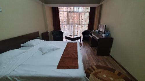 A bed or beds in a room at Guest House Bulevard