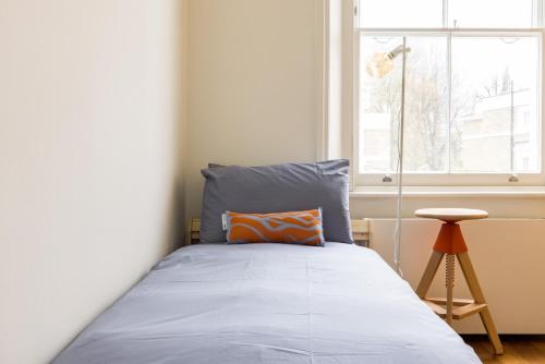 a bedroom with a bed and a window at Stunning Notting Hill APT, Beautiful Street in London