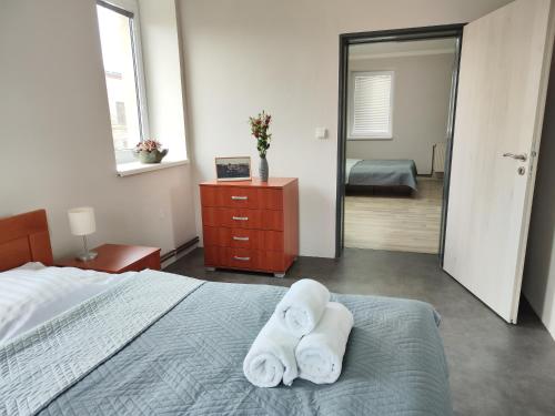 a bedroom with a bed with two towels on it at Ubytování Goliáš in Krásná Lípa