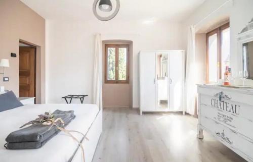 ein großes weißes Schlafzimmer mit einem Bett und einer Kommode in der Unterkunft B&B La Dolce Casa Lago di Como in Cremia