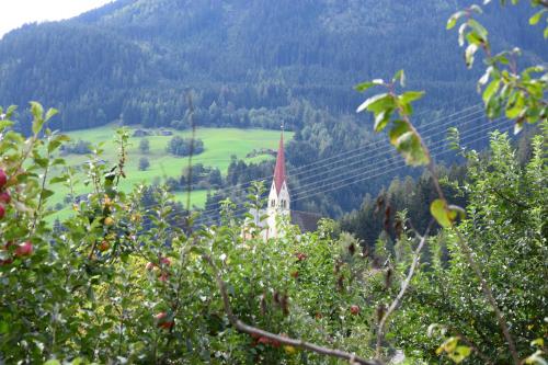 a view of a valley with a church on a hill at Ferienhaus Oberhuben in Fügenberg