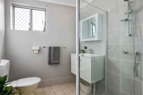 a bathroom with a shower and a toilet and a sink at Quiet & Comfy in Hamilton Hill