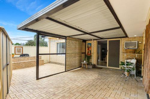 an open patio with awning on a house at Quiet & Comfy in Hamilton Hill