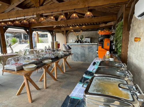 a group of tables in a kitchen with pots and pans at La Villa Dune, Hôtel & Spa in Saint-Tropez