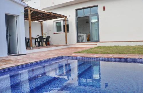 a swimming pool in front of a house at Casa Aqua in El Guijo