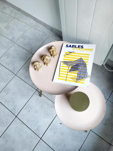 a magazine sitting on top of a toilet at Remblai des Sables d'Olonne - 2 chambres - parking et piscine in Les Sables-dʼOlonne