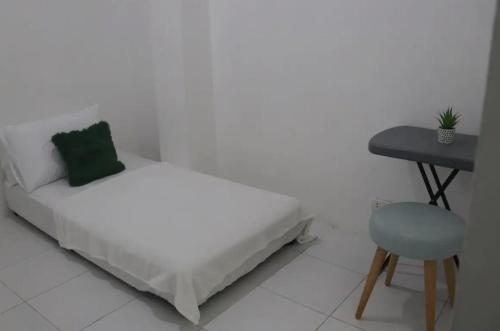 a bedroom with a bed and a table and a chair at PORTSIDE STUDIOS in Manila