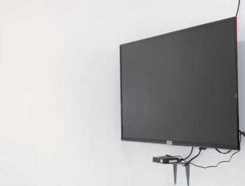 a flat screen tv hanging on a white wall at PORTSIDE STUDIOS in Manila