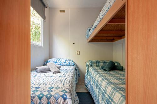 a bedroom with two beds and a staircase at Oasis on the river 2 in Marina di Pisa