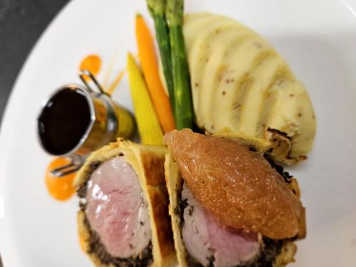 a plate of food with a sandwich and vegetables at Beech Hill Hotel & Spa in Windermere