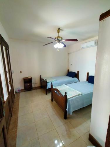a bedroom with two beds and a ceiling fan at Lazorde bay Sidi Abd El Rahman لازوردى باى apartment in El Alamein