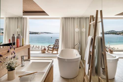 a bathroom with a sink and a view of the ocean at Zel Mallorca in Palmanova
