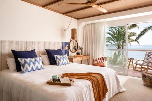 a bedroom with a large bed with a view of the ocean at Zel Mallorca in Palmanova