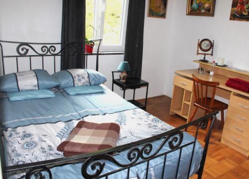 a bedroom with a bed and a desk and a chair at Art house Tufi in Bistrica ob Sotli