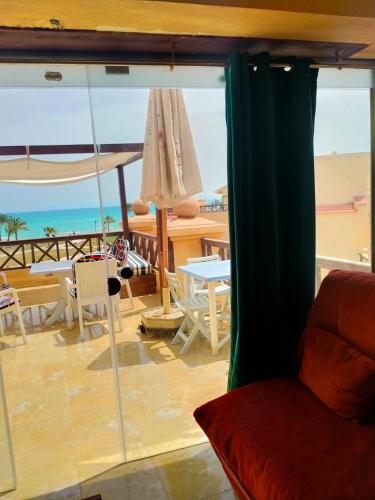 a living room with a view of the beach at Lazorde bay Sidi Abd El Rahman لازوردى باى apartment in El Alamein