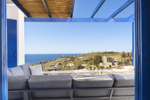 a couch in a room with a view of the ocean at Konstantinos and Eleni's Apartment in Koundouros
