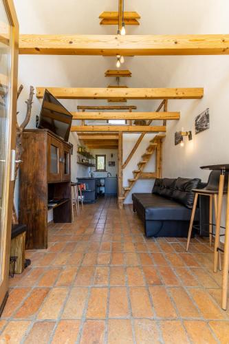 a living room with a couch and wooden ceilings at GORIČKE IŽE in Križevci